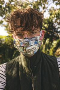 college student on campus wearing medical mask, gray vest and glasses