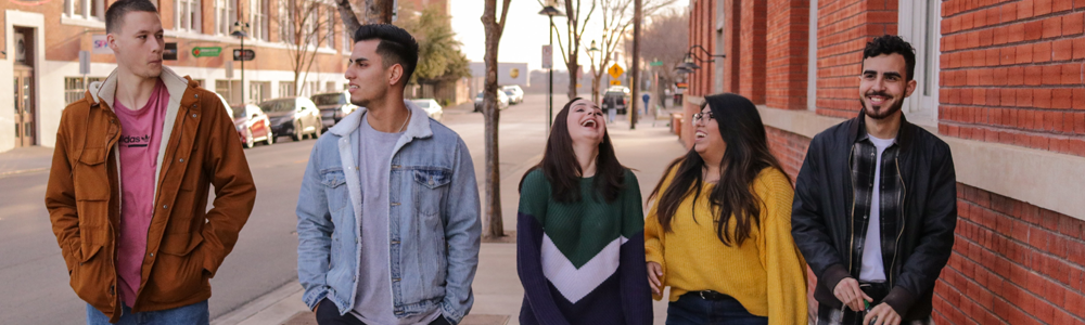 group of young adults laughs and walks together